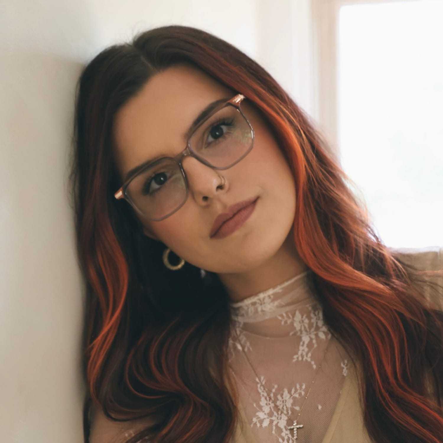 Portrait of Kara, a professional stylist at Stella Beauty, showcasing their expertise and style.